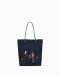 Forest Trail shoulder bag, made of eco-friendly denim with hand-embroidered wildflower decorations.