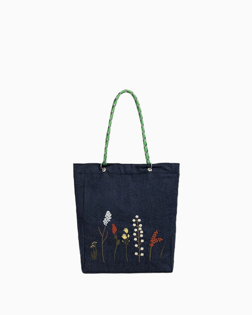Forest Trail shoulder bag, made of eco-friendly denim with hand-embroidered wildflower decorations.