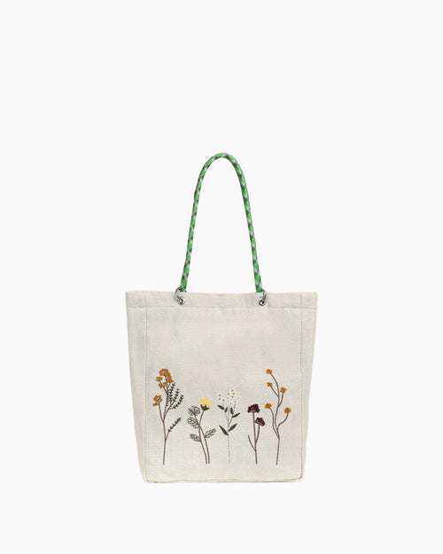 Forest trail shoulder bag with earthy tones, textured fabric panels, natural stitching details, soft structure, and an outdoor-inspired silhouette